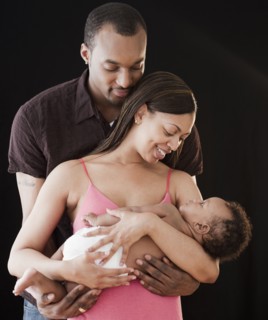 African couple holding sleeping baby