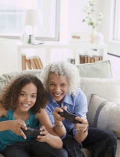Grandmother and granddaughter playing video game