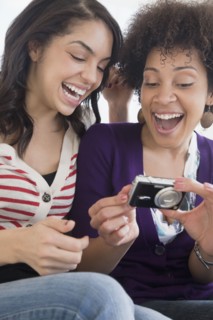 Friends looking at photographs on digital camera