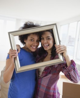 Friends looking through empty frame