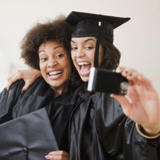 Graduating friends taking self-portrait