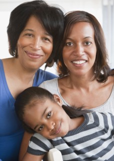 Black grandmother smiling with daughter and granddaughter