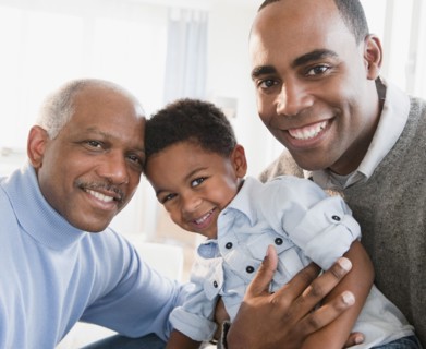 African American grandfather smiling with son and grandson