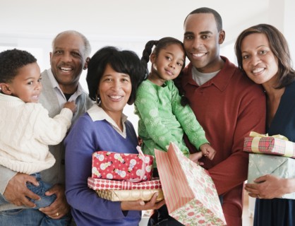 African American family holding Christmas gifts