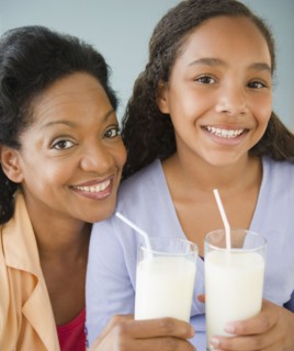 Mother and daughter drinking milk together