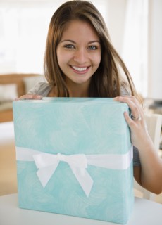 Smiling Indian woman holding birthday gift