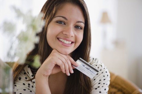 Smiling Indian woman holding credit card