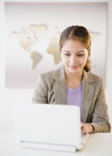 Indian businesswoman using laptop in office
