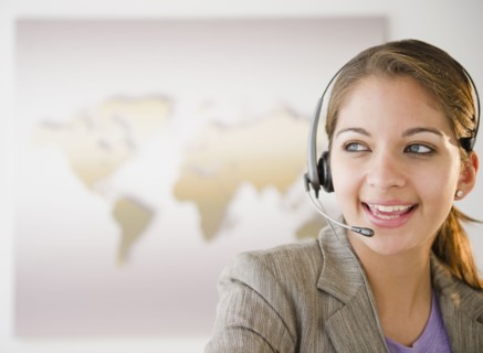 Indian businesswoman talking on headset in office