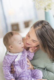 Caucasian mother playing with baby with Down Syndrome