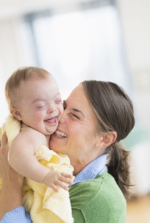 Caucasian mother playing with baby girl with Down Syndrome