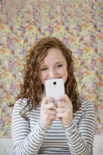 Caucasian woman taking cell phone selfie