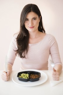 Caucasian woman preparing to eat TV dinner
