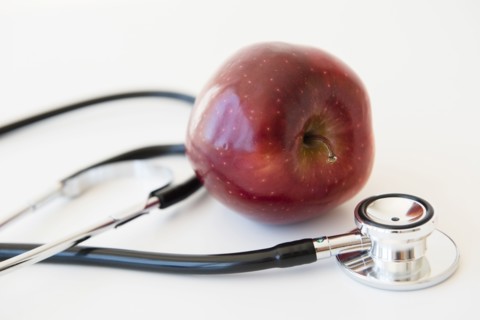 Stethoscope and red apple