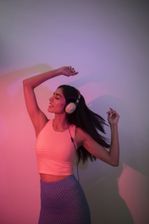 Indian woman dancing near wall casting shadow