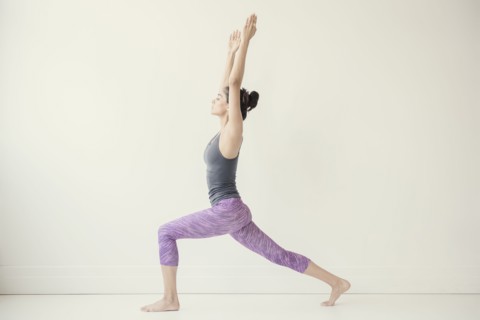 Indian woman with arms raised yoga pose
