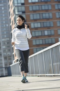 Hispanic woman running in city