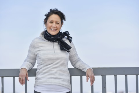 Hispanic woman leaning on railing