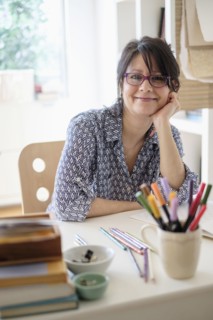 Hispanic woman smiling in home office