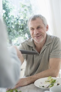 Older Caucasian man  paying bill in restaurant