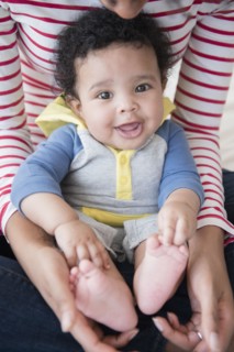Mother holding baby son in lap