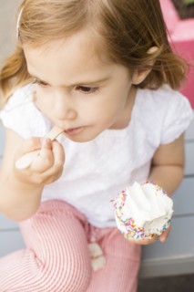 Caucasian girl eating ice cream with spoon