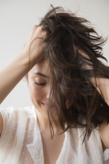 Hispanic woman tossing hair