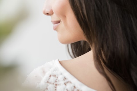 Hispanic woman smiling over shoulder
