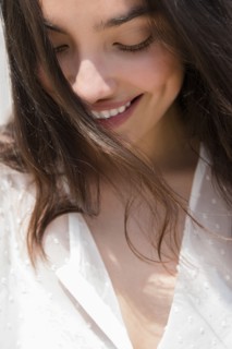Hispanic woman smiling in wind