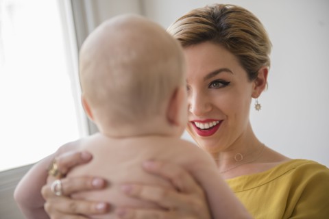 Caucasian woman holding baby boy