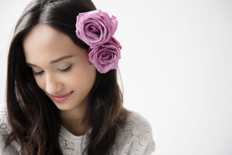 Mixed Race woman with roses in hair
