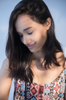 Smiling Mixed Race woman with eyes closed