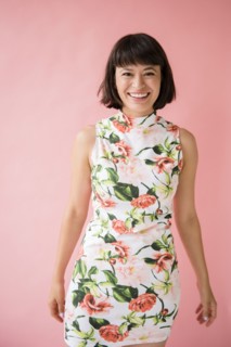 Smiling Hispanic woman wearing floral dress
