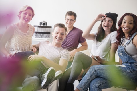 Portrait of smiling friends in livingroom