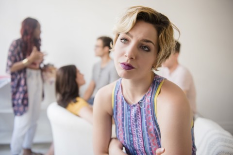Portrait of woman sulking at party