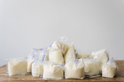 Bags of frozen breast milk on table