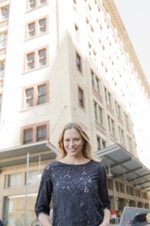 Portrait of smiling Caucasian woman standing in city
