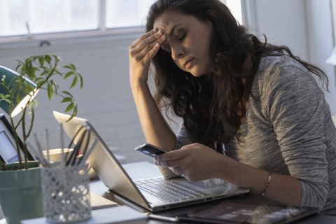 Hispanic businesswoman using technology in office