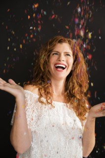 Confetti falling on celebrating Caucasian woman