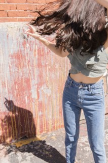 Thai woman dancing on city sidewalk