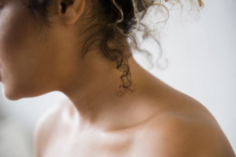 Neck and bare shoulders of Mixed Race woman