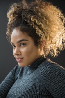 Portrait of Mixed Race woman wearing sweater
