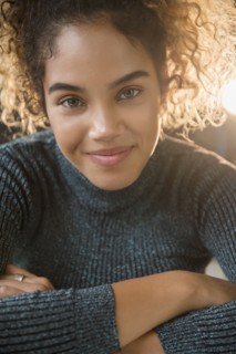 Smiling Mixed Race woman wearing sweater