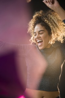Mixed Race woman wearing sweater dancing