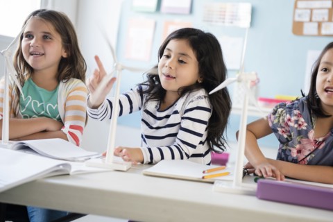 Girls learning about windmills in classroom