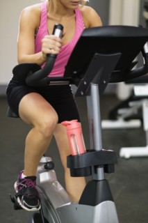 Mixed Race woman riding stationary bicycle