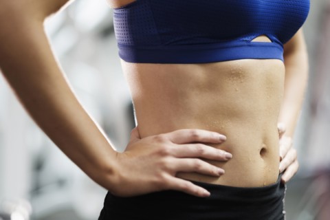 Sweating midriff of Mixed Race woman