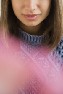 Lips of Mixed Race woman wearing blue sweater
