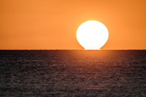Sunset on horizon of ocean