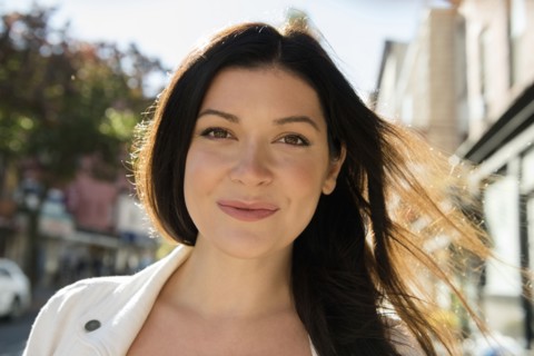Wind blowing hair of smiling Caucasian woman